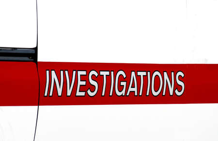 Sign on the side of a fire department vehicle that says investigations