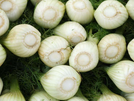 Fennel stacked for sale at an outdoor marketの写真素材