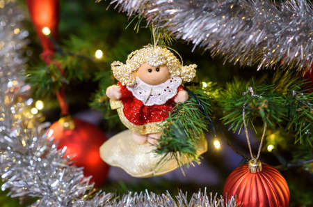 Christmas tree toy  in white-red dress on a Christmas tree in a Polish home, Christmas Eve,...