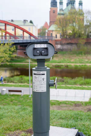 Poznan, wielkopolskie, Poland, 01.05.2021:Field glasses near Cybina river in Poznan, Poland, with the view on Bishop's Jordan Bridge and Basilicaのeditorial素材