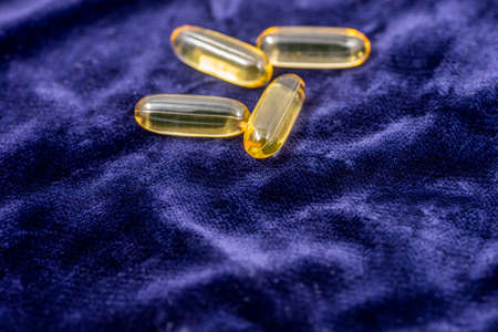 Fish oil capsules. Located on a colored background.の写真素材