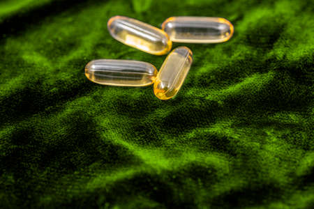 Fish oil capsules. Located on a colored background.の写真素材