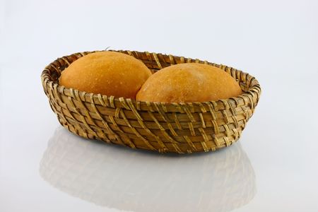  fresh baked rolls in a basket on whiteの写真素材