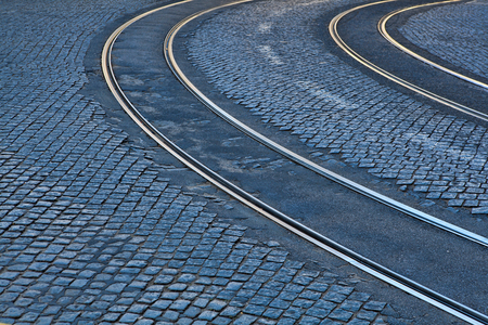 Old rail lines on cobbled road surfaceの写真素材