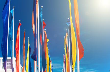 Colourful flags against the blue sky