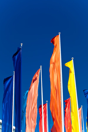 Colourful flags against the blue skyの写真素材