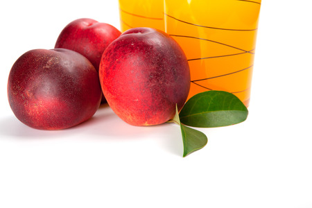 two glasses of juice and fresh peaches  on white backgroundの写真素材