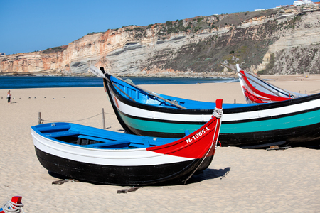 Nazare, Portugal - November 5, 2017: colorful traditional old wooden fishing boat on the beach of fishing village of Nazare .のeditorial素材