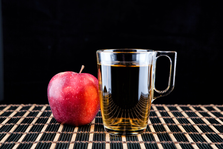 Apple juice and a box of red apples. Black backgroundの写真素材