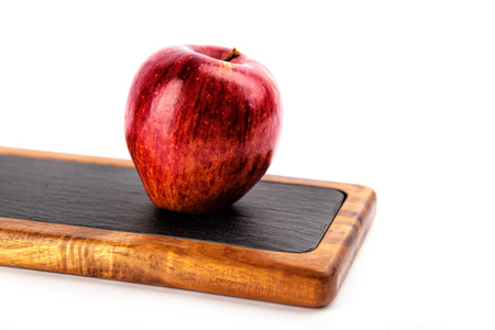 apple on a cutting board , isolated on a white backgroundの写真素材