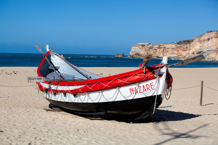 Nazare, Portugal - November 5, 2017: colorful traditional old wooden fishing boat on the beach of fishing village of Nazare .のeditorial素材