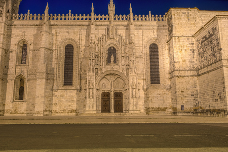 Facade of the Jeronimos (Hieronymites) Monastery in the Belem district of Lisbon illuminated at nightのeditorial素材