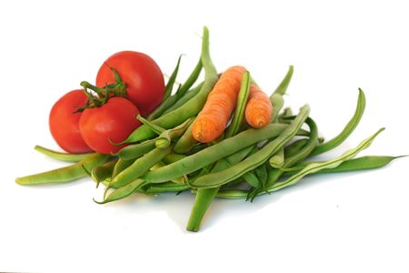 Green beans, tomatoes and carrots on a white backgroundの写真素材