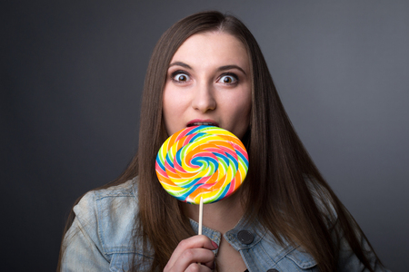 Young girl with big candyの写真素材