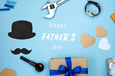 Happy fathers day composition. Various masculine items on blue background. Greeting card with text. Top view flat lay.の写真素材