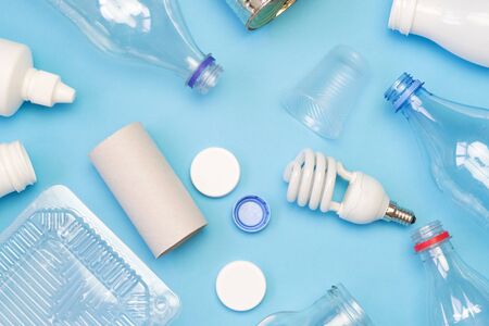 Different types of garbage on blue background. Sorting waste and recycling concept. Ecology and environmental care. Top view flat lay.の写真素材
