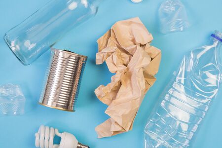 Different types of garbage on blue background. Sorting waste and recycling concept. Ecology and environmental care. Top view flat lay.の写真素材