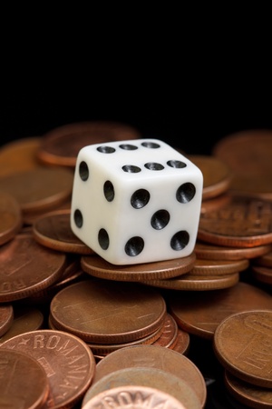 A white dice on the cooper coinsの写真素材