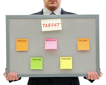 Businessman holding a reminder board with the target for the week