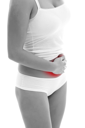 Young woman holding her stomach, having painの写真素材
