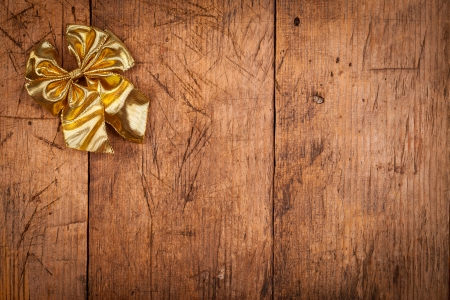 Small golden ribbon on rustic wooden background, Christmas concept
の写真素材