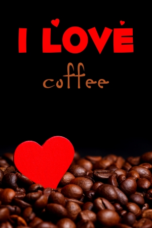 Closeup view of coffee beans with little red heart, black with place for your text on black
の写真素材