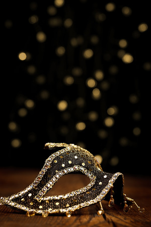 Ornate carnival mask with festive lights on black backgroundの写真素材
