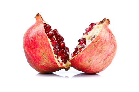 Pomegranate cut in halves over white backgroundの写真素材