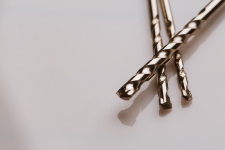 Drill bits of different sizes over white background.の写真素材