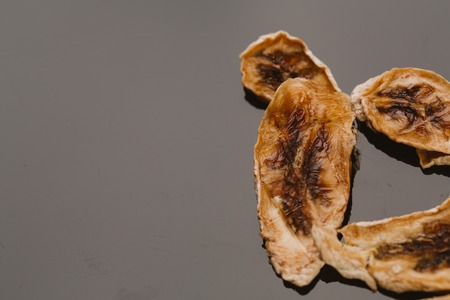 Dried fresh banana on a dark background.の写真素材