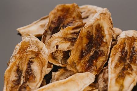 Dried fresh banana on a dark background.の写真素材