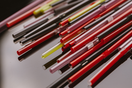 colored tubules for a cocktail on dark background.の写真素材