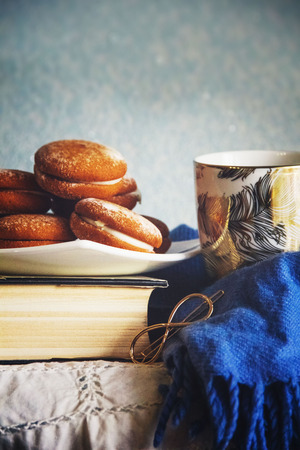 cookies on a white plate on a old bookの写真素材