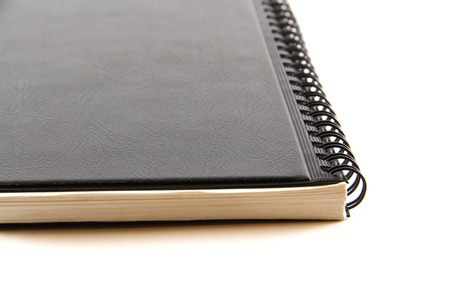 Black notebook on a white backgroundの写真素材