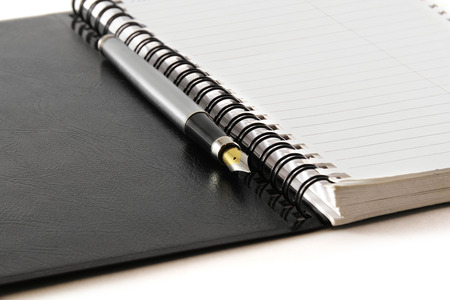 Black notebook on a white backgroundの写真素材