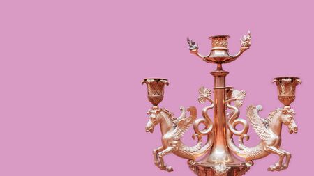 Vintage candlestick on pink wall background. Conceptual view.の写真素材