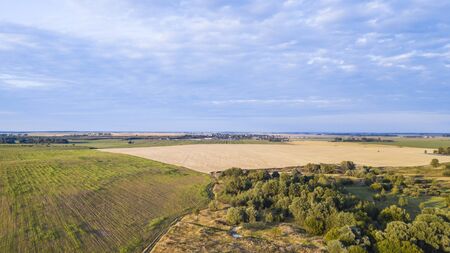aerial view of autumn harvest field and blue sky. Texture view.