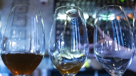 Wineglass with white and rose wine on the bars stand.の写真素材