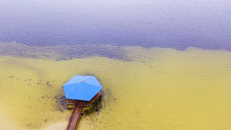 Aerial view of gazebo with classic blue roof, yellow sand and clear water. Relax concept.の写真素材