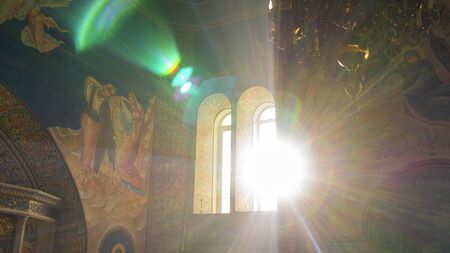 Bright rays of the sun beating in the window of the orthodox church. Religious and easter concept.の写真素材