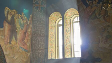 Bright rays of the sun beating in the window of the orthodox church. Religious and easter concept.