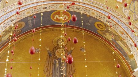 Easter decorations in a orthodox church. Ornamental easter egg garland. Religious concept.の写真素材