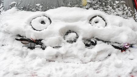 Smiley face drawing in the snow on a sunny dayの写真素材