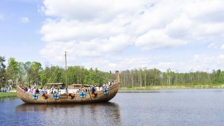 Minsk/Belarus - 05.21.2017: People on a boat named Drakkar swim on a lake in the Sula, recreation park near the Minsk.の写真素材