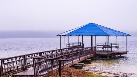 Winter holiday concept. Gazebo on the winter lake.の写真素材
