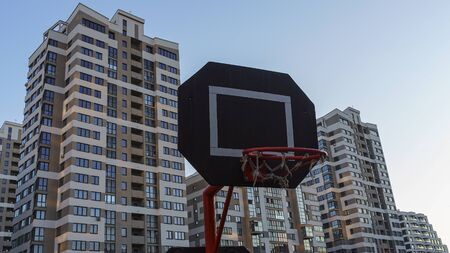 Basketball hoop with backboard in modern residential district on the classic blue sky background....