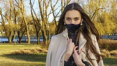 Fashionable black medical mask. Coronavirus 2019-ncov epidemic concept. Woman in a black medical...