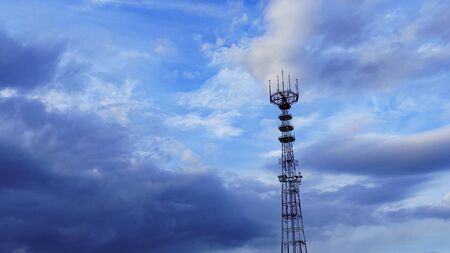 Panoramic view of big television and radio tower on the dramatic sky background. Space for text.