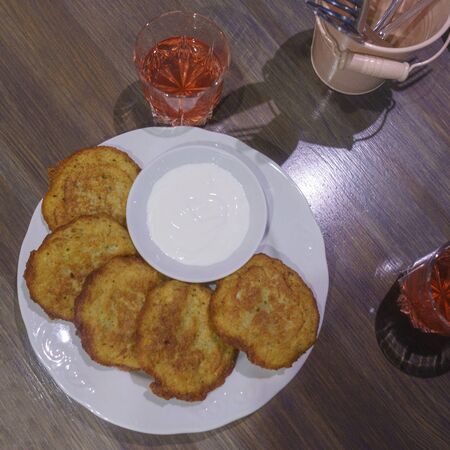 Potato pancakes, draniki, hash browns or fritters served with fresh cream.