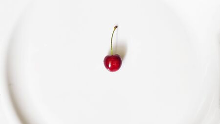 Top view of a cherry berry on a white background. Ripe cherrie texture. Space for text.の写真素材